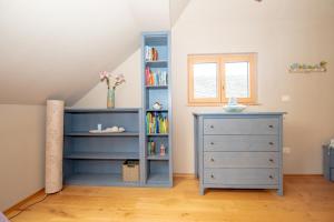 a bedroom with a blue book shelf and a dresser at House Bovecation in Bovec