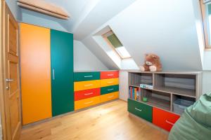 a room with colorful cabinets and a stuffed teddy bear at House Bovecation in Bovec