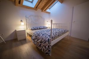 a bedroom with a bed with a blue and white bedspread at La Tana dell'Orso Lavarone in Lavarone