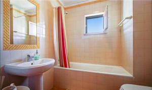 a bathroom with a sink and a tub and a toilet at Luz Paradise in Luz +25 photos