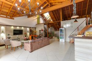 a large living room with a couch and a television at Zermatt Hotel in Gramado