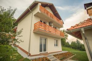 ein Haus mit einem Balkon darauf in der Unterkunft GardenLux Sarajevo in Sarajevo