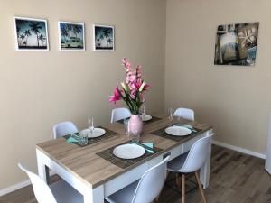 a dining room table with a vase of flowers on it at Monteur Apartment Rodenbach in Rodenbach