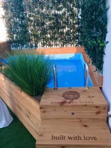a wooden box with a pool with plants in it at Dimore di Mare in San Pietro Vernotico