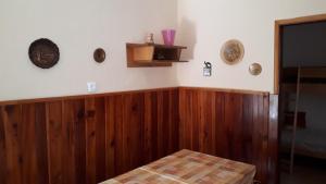 a living room with wood paneling and a tv at Peaceful old house in Bovec