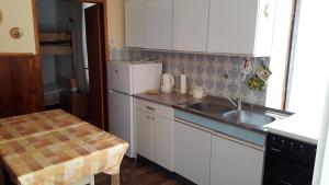 a kitchen with a sink and a white refrigerator at Peaceful old house in Bovec +22 photos