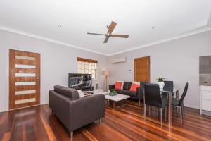 a living room with a couch and a table at 2 bedroom cottage in Townsville