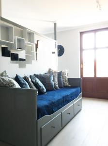 a bed with blue sheets and pillows in a room at L.D. SPA Apartment in Rewal