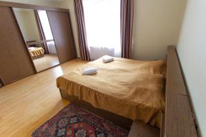 a bedroom with a bed with two towels on it at Eka&Nino GuestHouse in Mestia