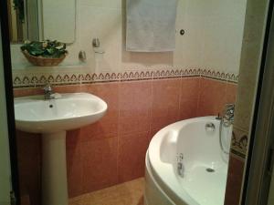ein Badezimmer mit einem Waschbecken und einer Badewanne in der Unterkunft Metro SAHIL Seaside Centr in Baku