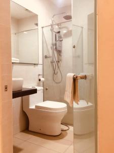 a bathroom with a shower and a toilet and a sink at The View Hotel in Segamat