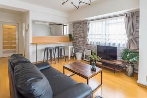 a living room with a couch and a table at Centrage Ark Shinsaibashi in Osaka