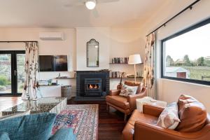 a living room with a couch and a fireplace at Esto house in Crafers