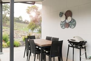 a dining room with a wooden table and chairs at Esto house in Crafers