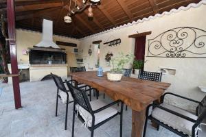 a dining room with a wooden table and chairs at Ktima Kallitero Villas in Argassi