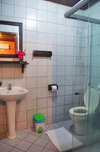 a bathroom with a toilet and a sink at Eurosol Pousada das Canoas in Pipa