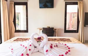 Postel nebo postele na pokoji v ubytování Umah Tikari Guesthouse