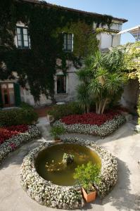 a garden with a small pond in front of a building at Hotel Parsifal - Antico Convento del 1288 in Ravello