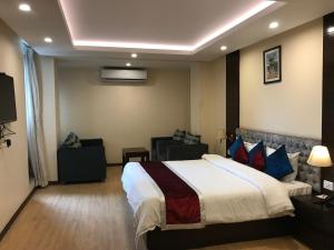 a hotel room with a bed and a couch at Kaveri Inn in Kathmandu