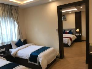 a bedroom with two beds and a large mirror at Kaveri Inn in Kathmandu