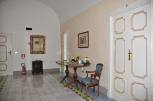 a room with a table and chairs and a door at Hotel Parsifal - Antico Convento del 1288 in Ravello