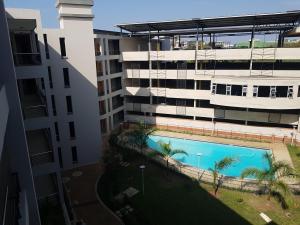 an overhead view of an apartment building with a swimming pool at Cyro Apartments at Central Park in Durban