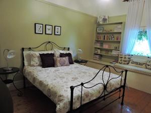 a bedroom with a bed and a window at Delightful Cottage in Queenscliff