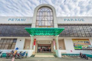a building with motorcycles parked in front of it at Northern Lodge Hotel in Sungai Petani