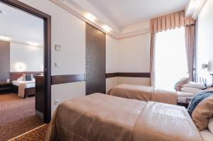 Postel nebo postele na pokoji v ubytování Hunguest Hotel Apollo