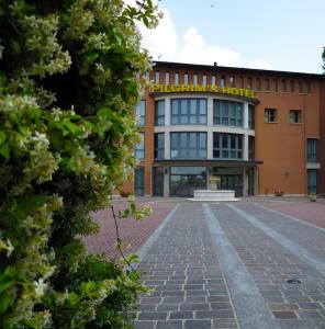 an orange building with a sign on it at Pilgrim's Hotel in Cicognolo