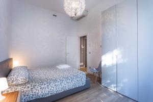 a bedroom with a bed and a glass wall at Udine Centre Stylish Apartment in Udine