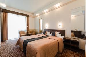 Postel nebo postele na pokoji v ubytování Hunguest Hotel Apollo