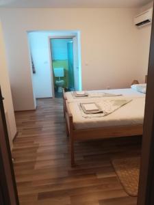a bedroom with a bed and a hallway with a bathroom at Sobe Pavlaković in Ozalj