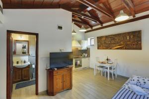 a kitchen with a table and a dining room at Diegos Apartments in Pula