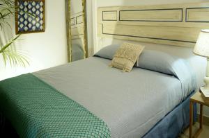 a bedroom with a bed with a blue comforter at Casagliana Suite Resort in Olbia