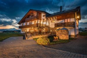 a building with lights on the side of it at Maravar - Beer Spa - Adults Only in Liptovský Trnovec