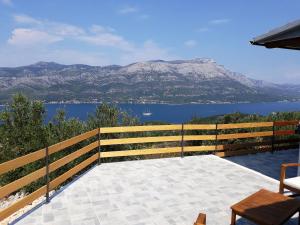 a patio with a view of the water and mountains at BELLAVISTA Luxury Lodge in Korčula