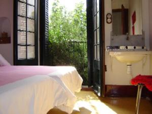 a bedroom with a bed and a sink and a window at Casas del Mar in Cadaqués