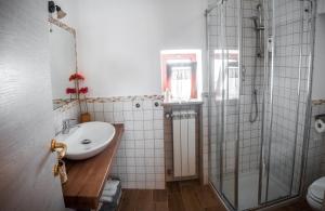 a bathroom with a sink and a shower at B&b A casa di Maybe in Caserta +14 photos