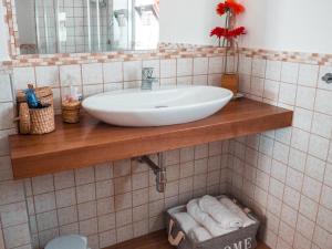 a bathroom with a sink on a tiled wall at B&b A casa di Maybe in Caserta
