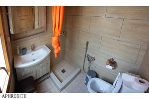 a small bathroom with a toilet and a sink at Medusa Gorgon in Develíkia +46 photos