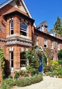 a large brick building with a window on it at Alma House Bed and Breakfast in Newbury