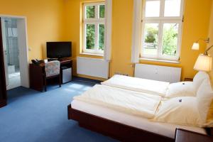 Кровать или кровати в номере Landhotel Zum Pottkuchen