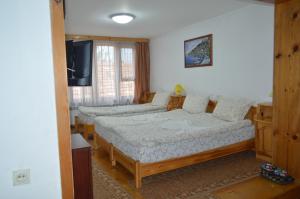 A bed or beds in a room at Baba Dora Guesthouse