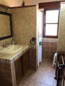 a bathroom with a sink and a mirror at Casa Collao 24 in Sierra +34 photos