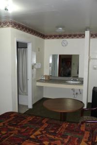 a hotel room with a table and a mirror at Choice Inn San Antonio in San Antonio