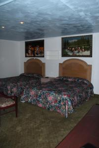 a bedroom with two beds and two pictures on the wall at Choice Inn San Antonio in San Antonio