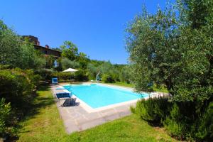 a swimming pool in the yard of a house at Villa Gioiosa in Monte San Savino