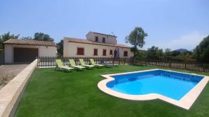 a yard with a swimming pool and chairs and a house at Ca'n Bernat in Son Servera