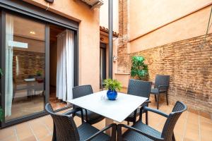 a patio with a table and chairs on a balcony at Flaugier Apartments in Barcelona